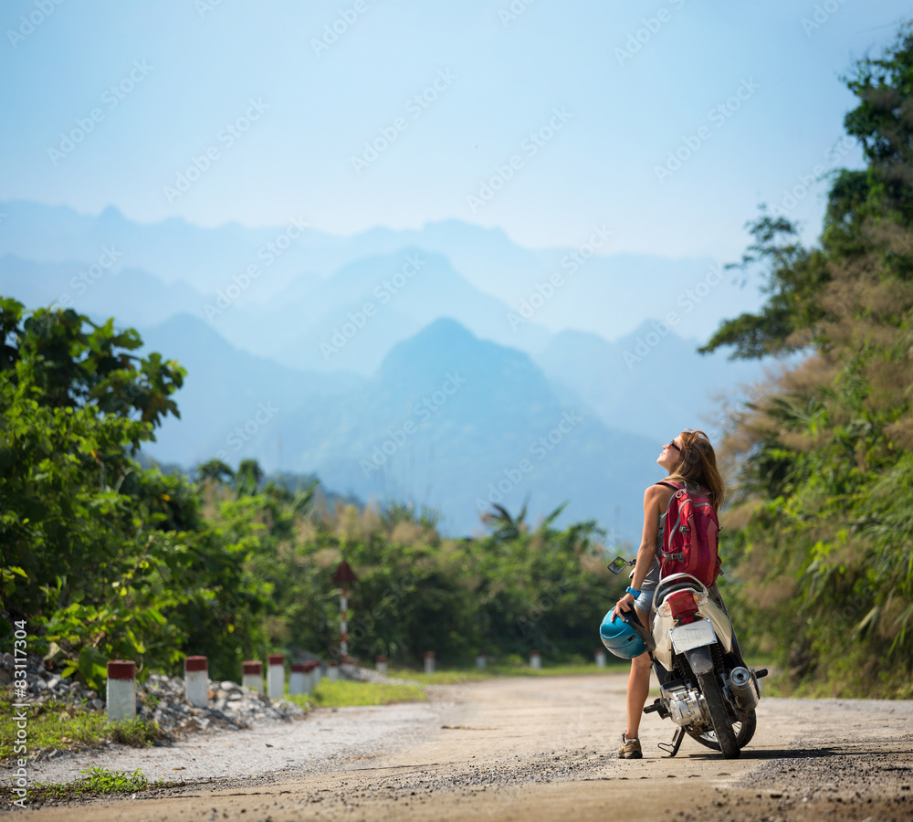 Obraz premium Lady biker near the scooter