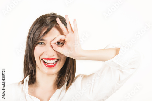 Happy smiling young woman showing okay gesture