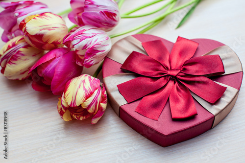 Tulips and boxes with gifts on a white background