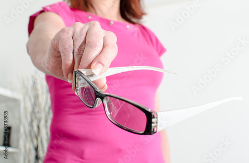 Woman hand showing glasses