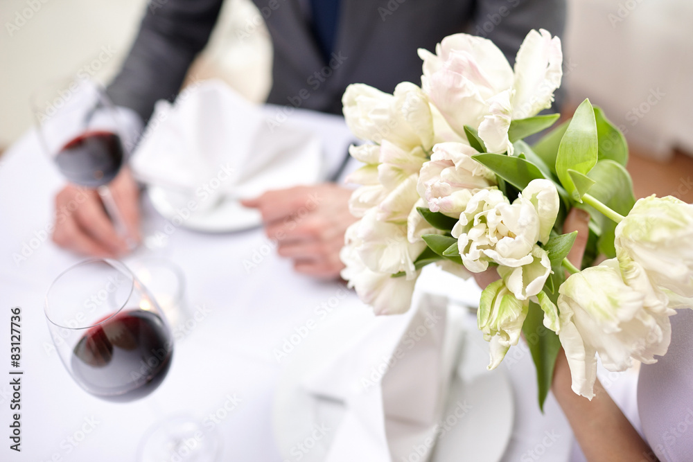 close up of couple with flowers at restaurant close up of couple with flowers at restaurant