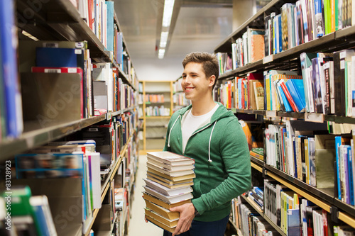 happy student or man with book in library