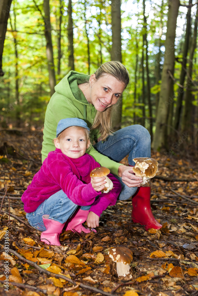mother with her daughter doing mushroom picking mother with her daughter doing mushroom picking