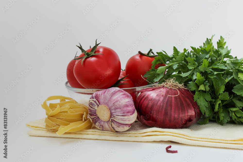 Vegetables for coocking pasta: garlic, onion, tomato, parley Vegetables for coocking pasta: garlic, onion, tomato, parley