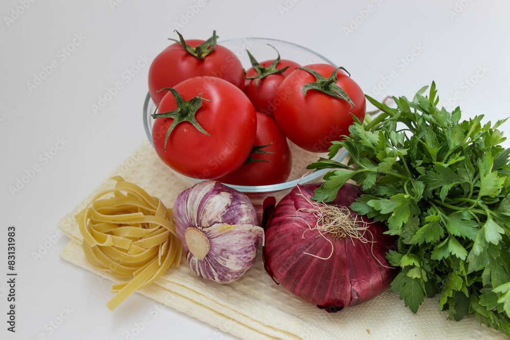Vegetables for coocking pasta: garlic, onion, tomato, parley