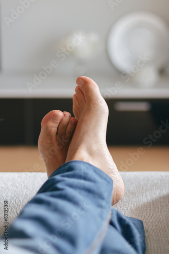 Man lying on the couch photo