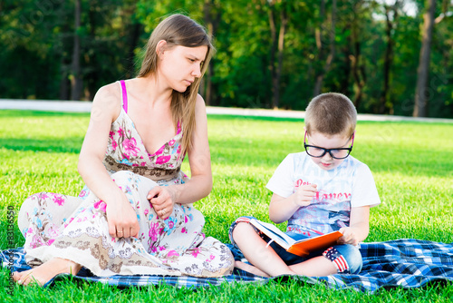 Mother and son in the park on the grass, family © kostyha