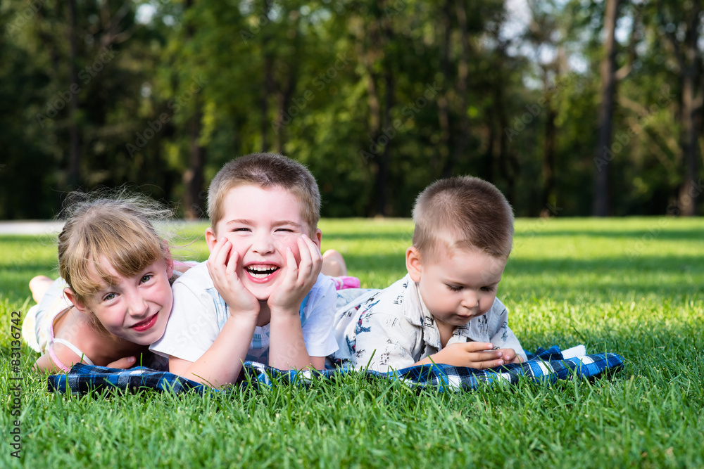 Beautiful children in the park on the grass Beautiful children in the park on the grass