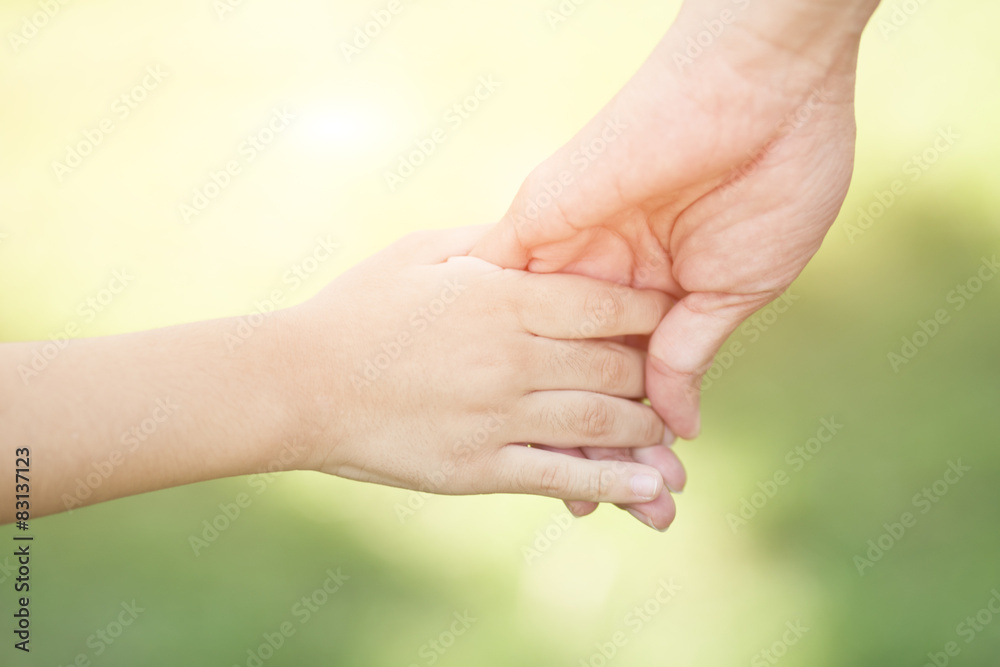 Mother holding a hand of his son in summer day Mother holding a hand of his son in summer day