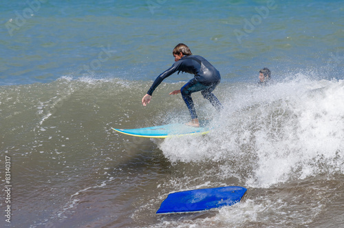 Photography Surfing on the ocean waves. One surfer lost board.