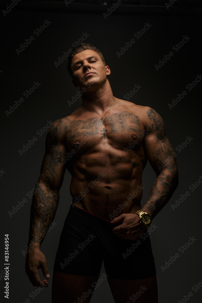 Muscular guy in deep shadows Muscular guy in deep shadows