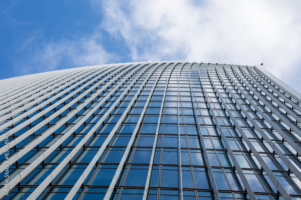 A clouds reflection in glass wall of business building A clouds reflection in glass wall of business building