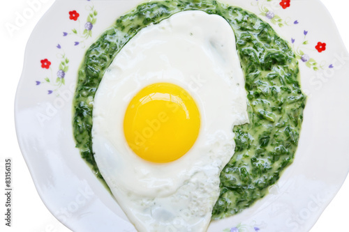 Fried egg with spinach dip over white