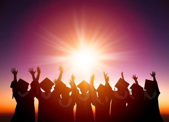 silhouette of Students Celebrating Graduation watching the sunli