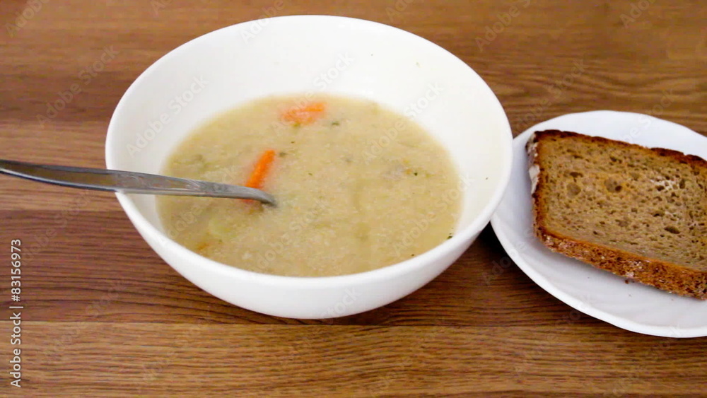 bowl with soup and bread on wooden background. Full HD bowl with soup and bread on wooden background. Full HD