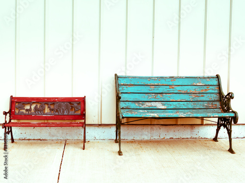 Two empty colorful wooden benches Fototapeta