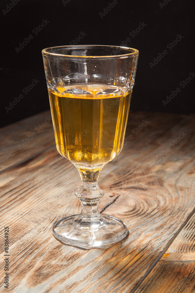 Glass with white wine on a wooden table Glass with white wine on a wooden table