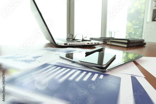 business documents on office table with smart phone and digital