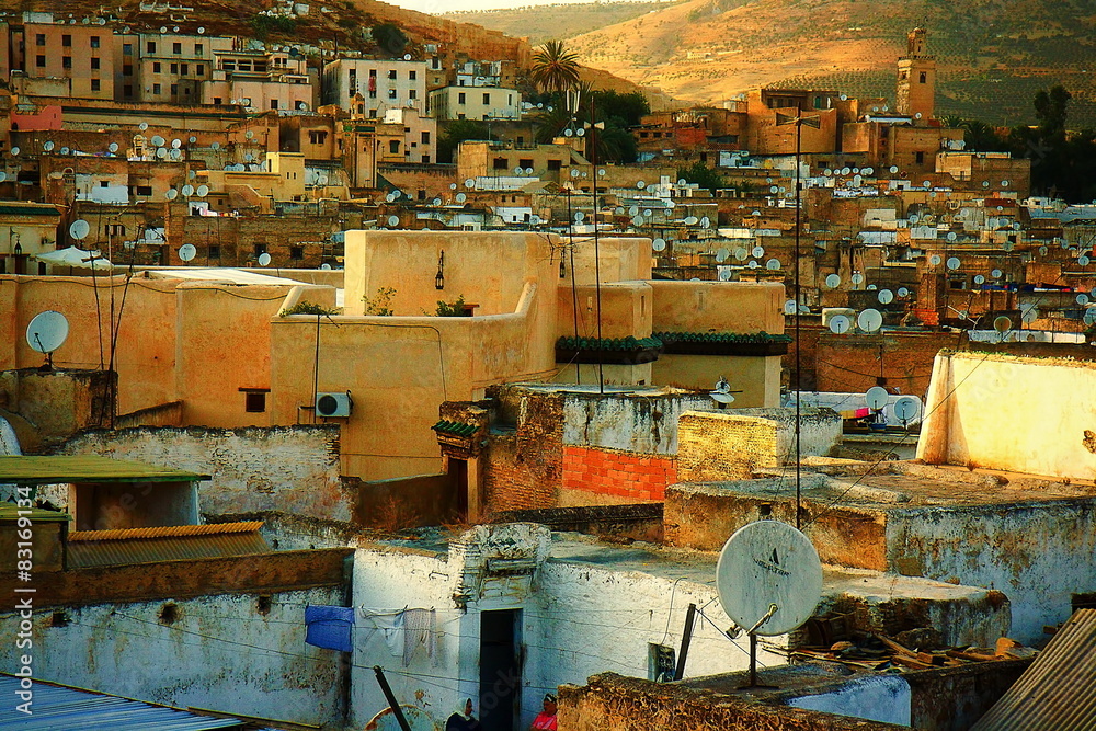 Moroccan town in sunlight. Satellites on the roofs of an ancient