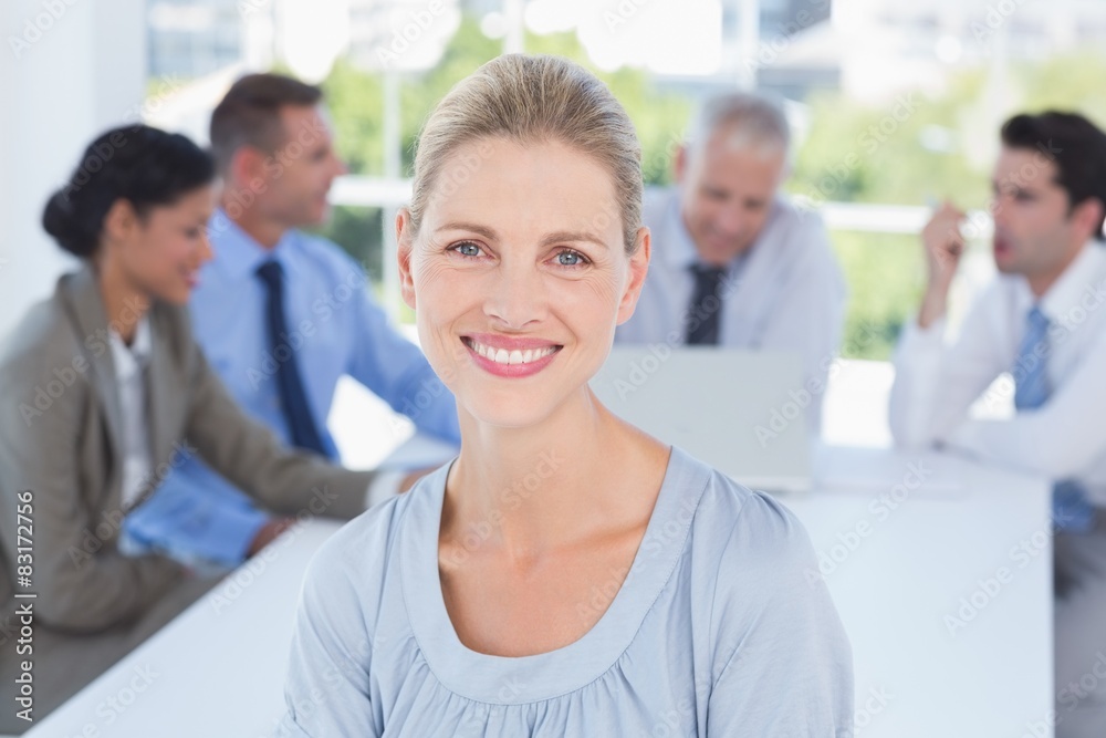 Smiling businesswoman and her team Smiling businesswoman and her team