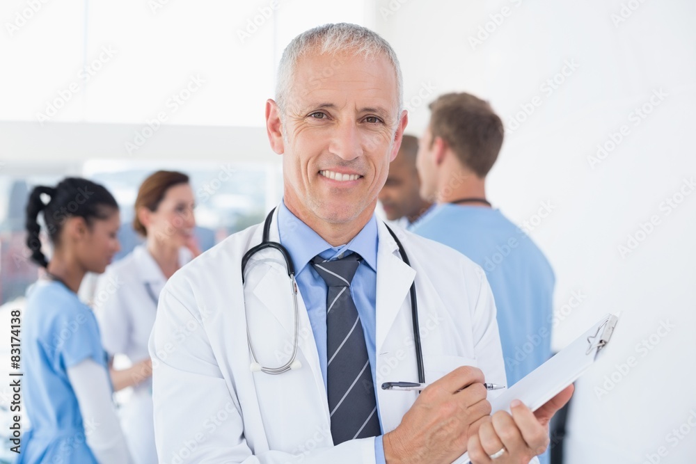 Confident male doctor smiling at camera Confident male doctor smiling at camera