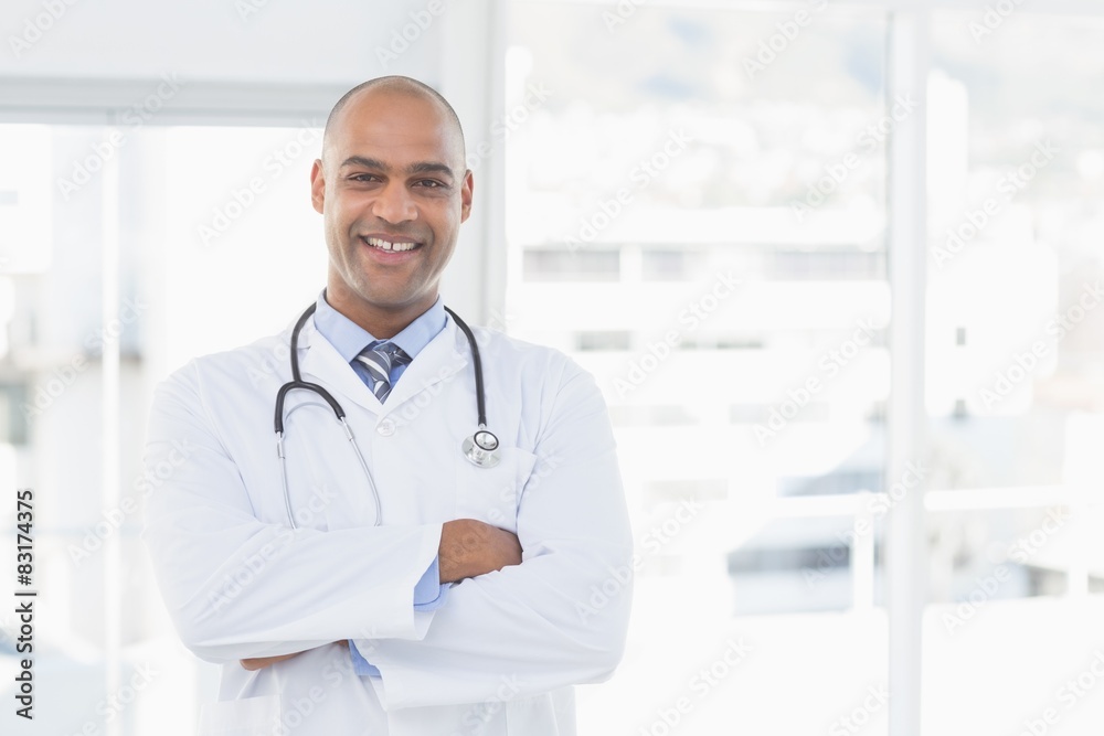 Confident male doctor smiling at camera Confident male doctor smiling at camera