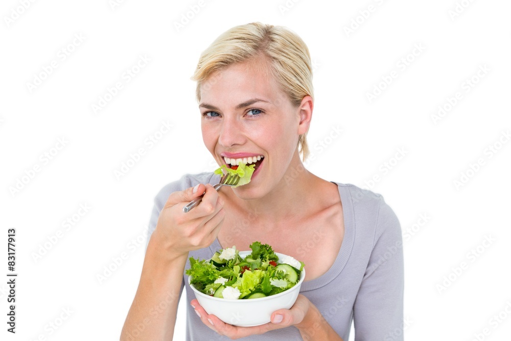 Happy blonde woman holding bowl of salad Happy blonde woman holding bowl of salad
