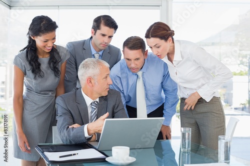 Business team working together on laptop