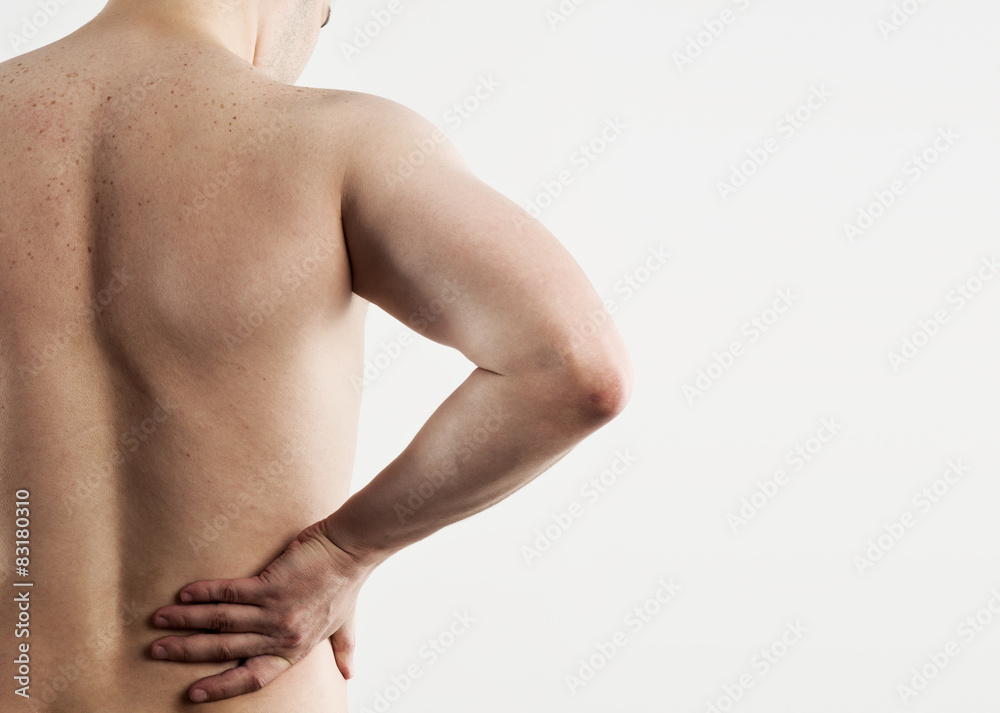 Naklejka premium Portrait of young man suffering from spine disease over grey