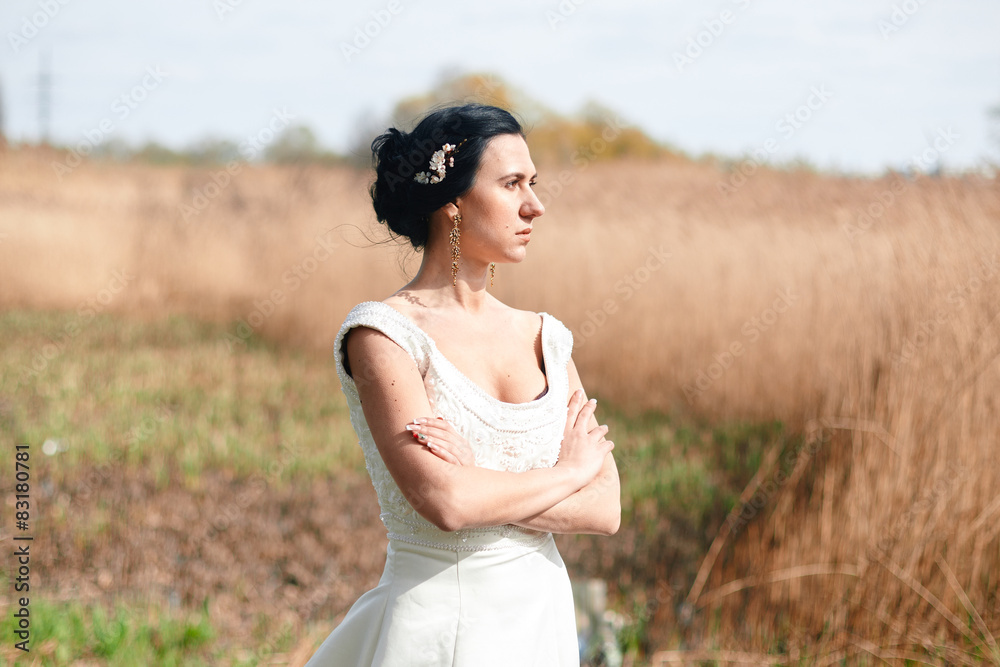The lonely bride with flowers in a hairstyle The lonely bride with flowers in a hairstyle