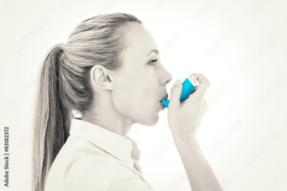 Pretty blonde using an asthma inhaler