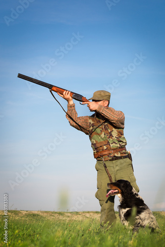 Hunter with a dog on the field