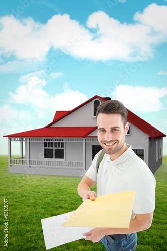 Composite image of happy derivery man giving envelop photo