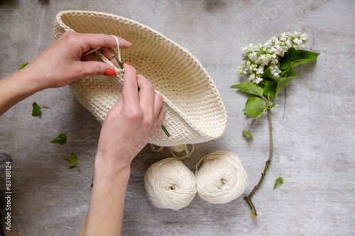 hand crochet and blue threads on wooden table