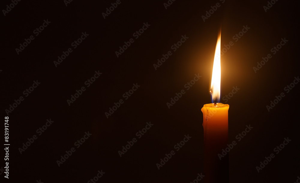 Fototapeta premium Candle light in darkness as light for life