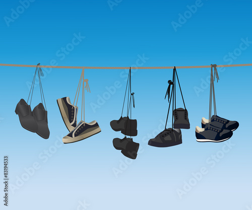 The footwear hanging on a rope.