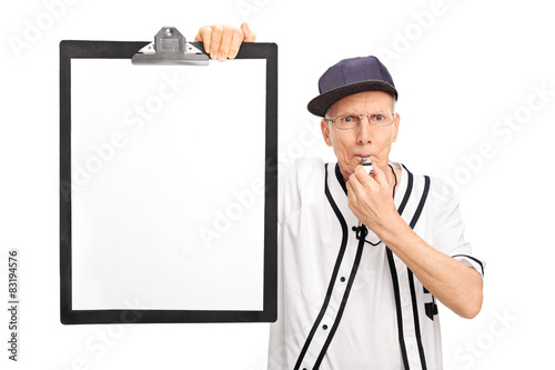 Photography Elderly baseball coach holding a clipboard