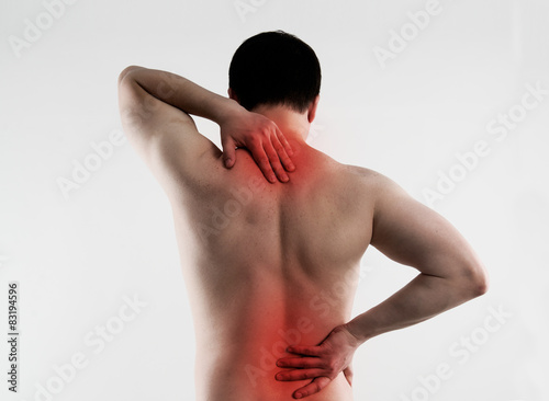 Foto Backache. Young person suffering from lumbar vertebrae disease