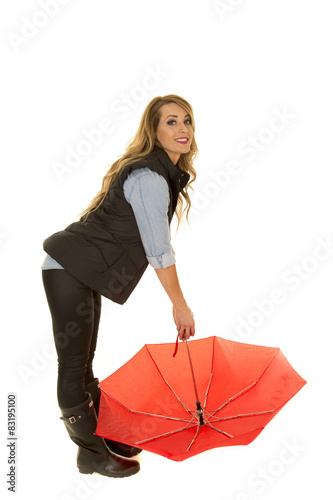 woman in a black jacket lean over with umbrella © Poulsons Photography