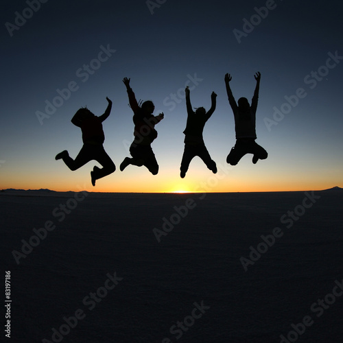 Happy friends jumping outdoor