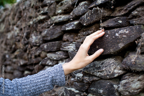Obraz na płótnie Touching the stone wall women hand w salonie