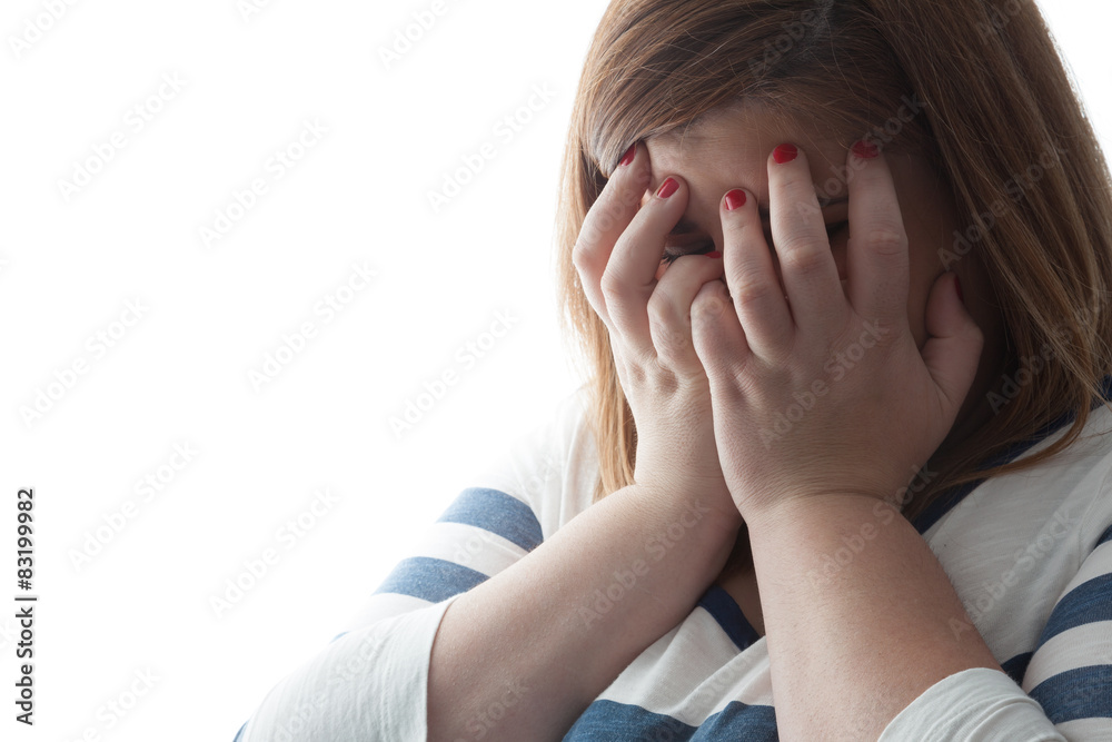 Woman covering her face with hands. Backlight.