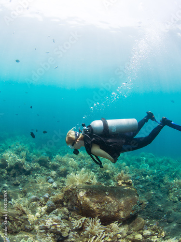 Female diver over a coral reef
