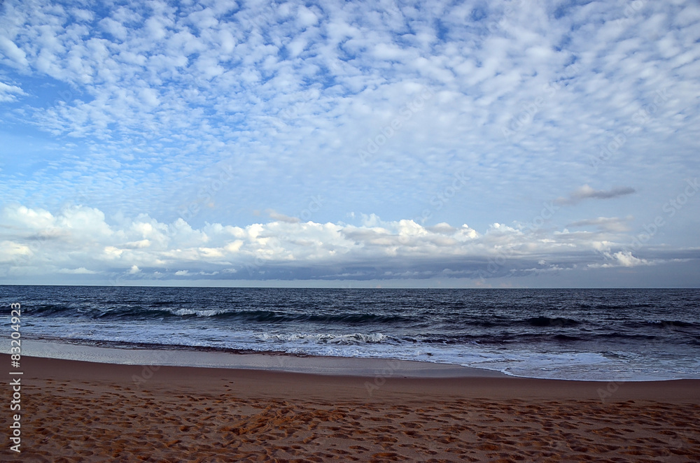 beach and blue cloudy sky by the sea on sundown