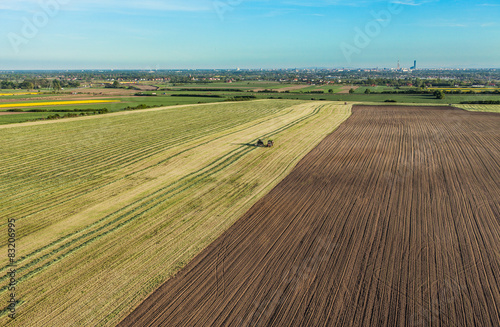 aerial view of harvest fields with combine and tractor