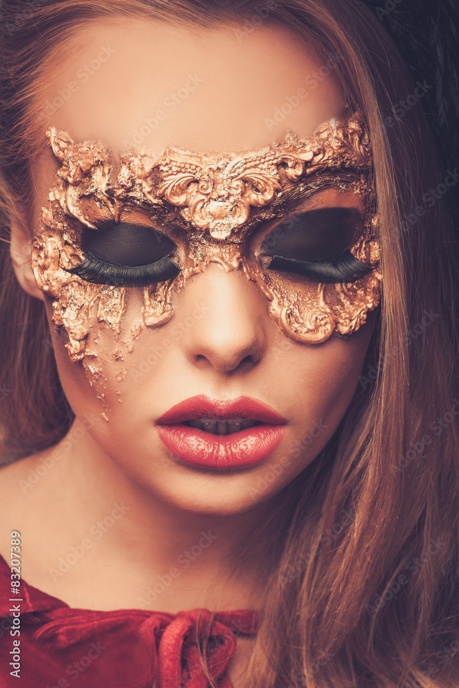 Woman with creative carnival mask on her face