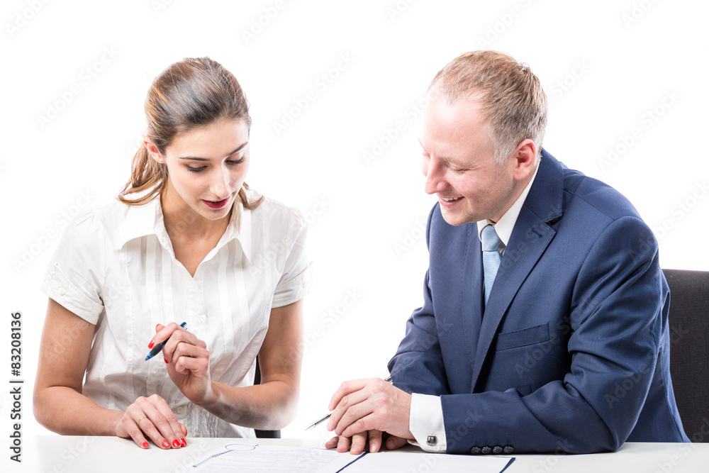 Businessman and businesswoman signing a papers Businessman and businesswoman signing a papers