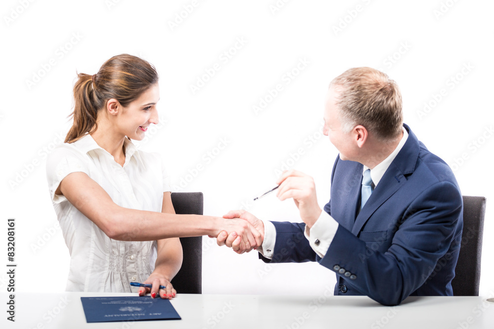 Businessman and businesswoman signing a papers Businessman and businesswoman signing a papers