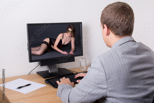xxx concept - man looking adult content on computer in office