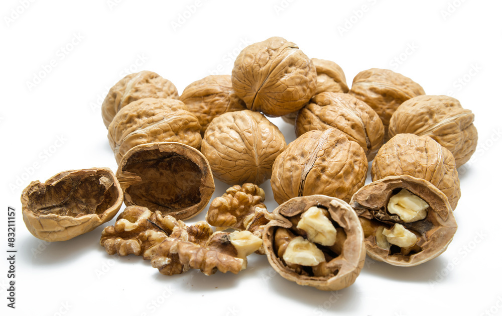 walnut and a cracked walnut on the white background walnut and a cracked walnut on the white background